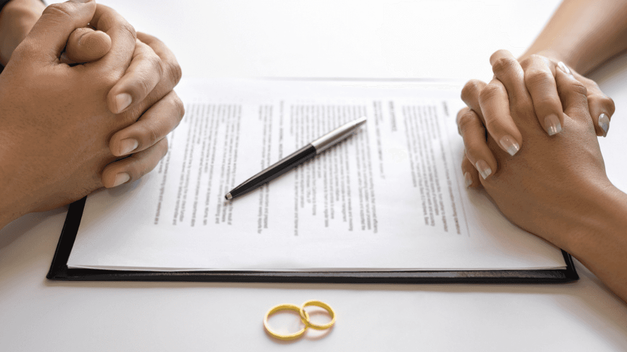 Two people signing divorce papers