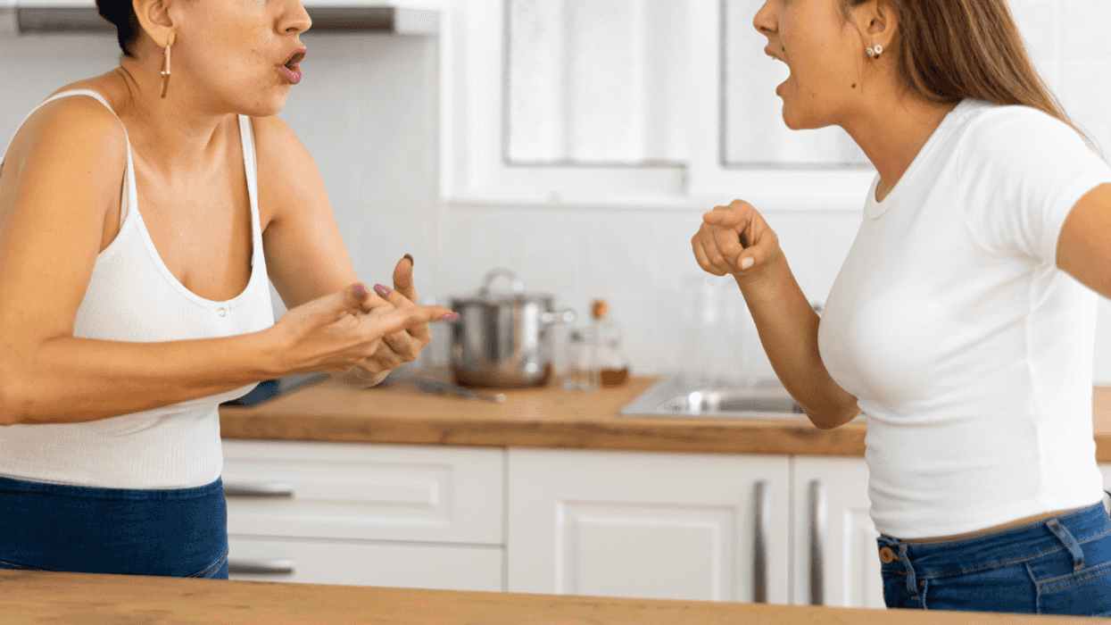 two women arguing in a kitchen