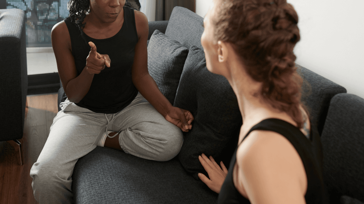 two women arguing on couch