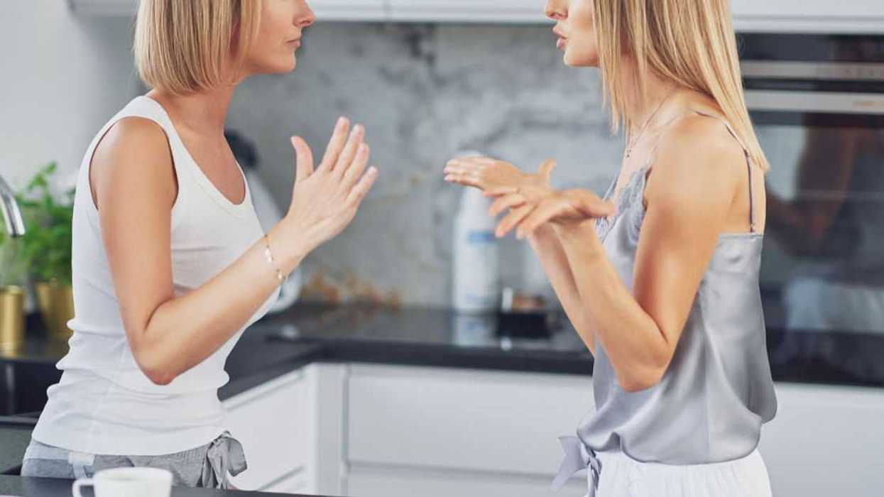 Two women in the kitchen are arguing