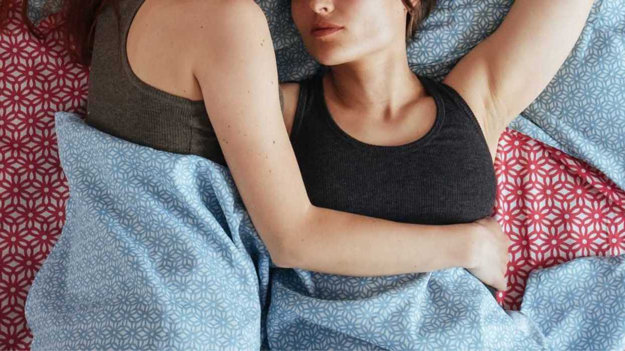 Two women lie in bed together