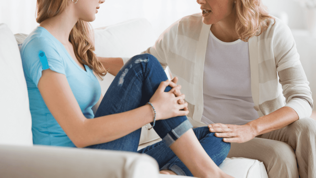 Two women sitting and having an argument.