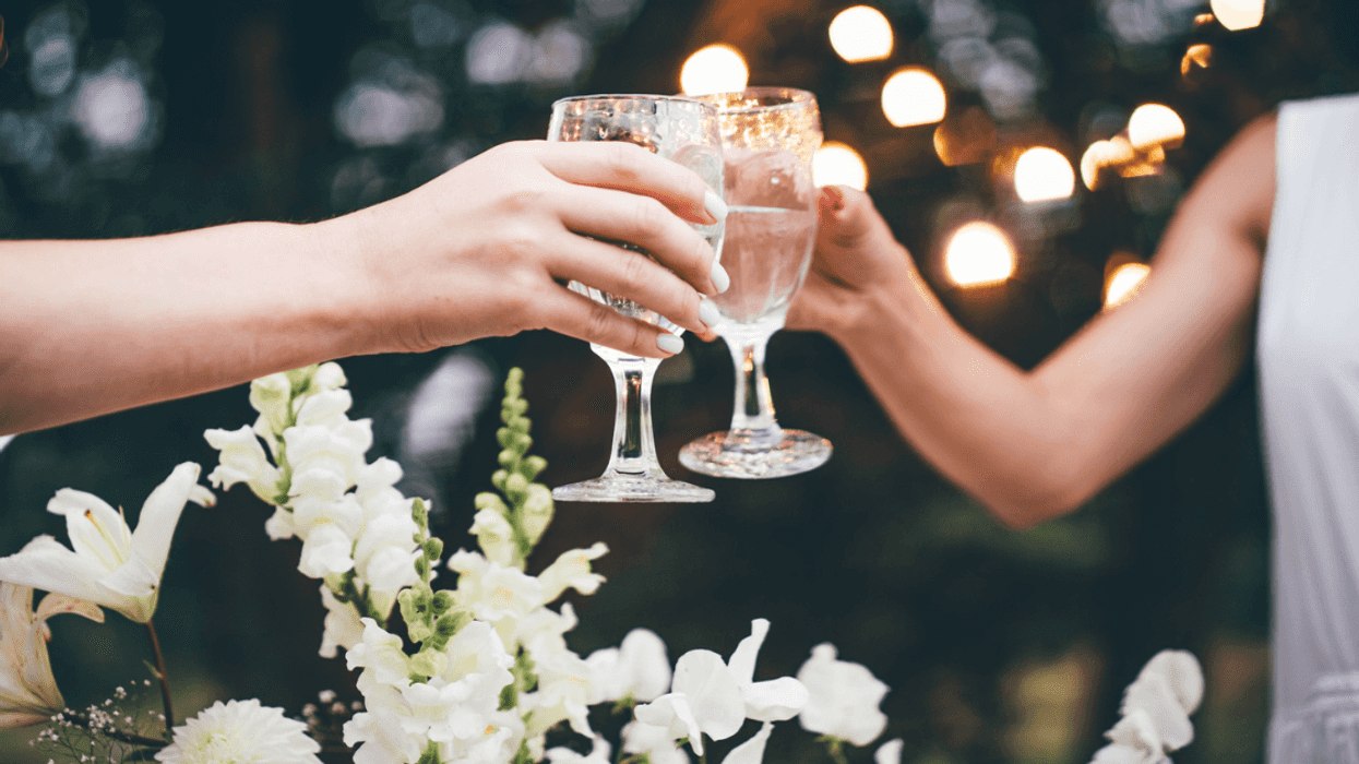 Two. women toasting with water.