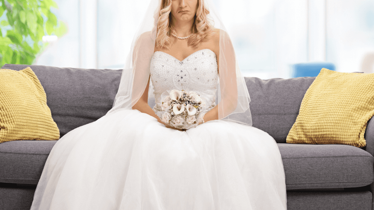 unhappy bride seated on couch