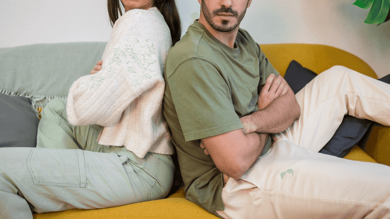 unhappy couple seated back to back with crossed arms