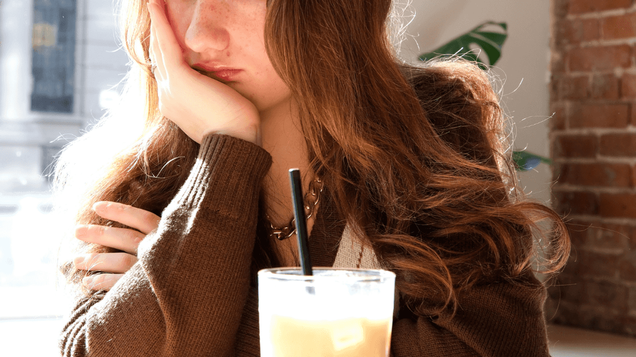 unhappy teen girl in restaurant