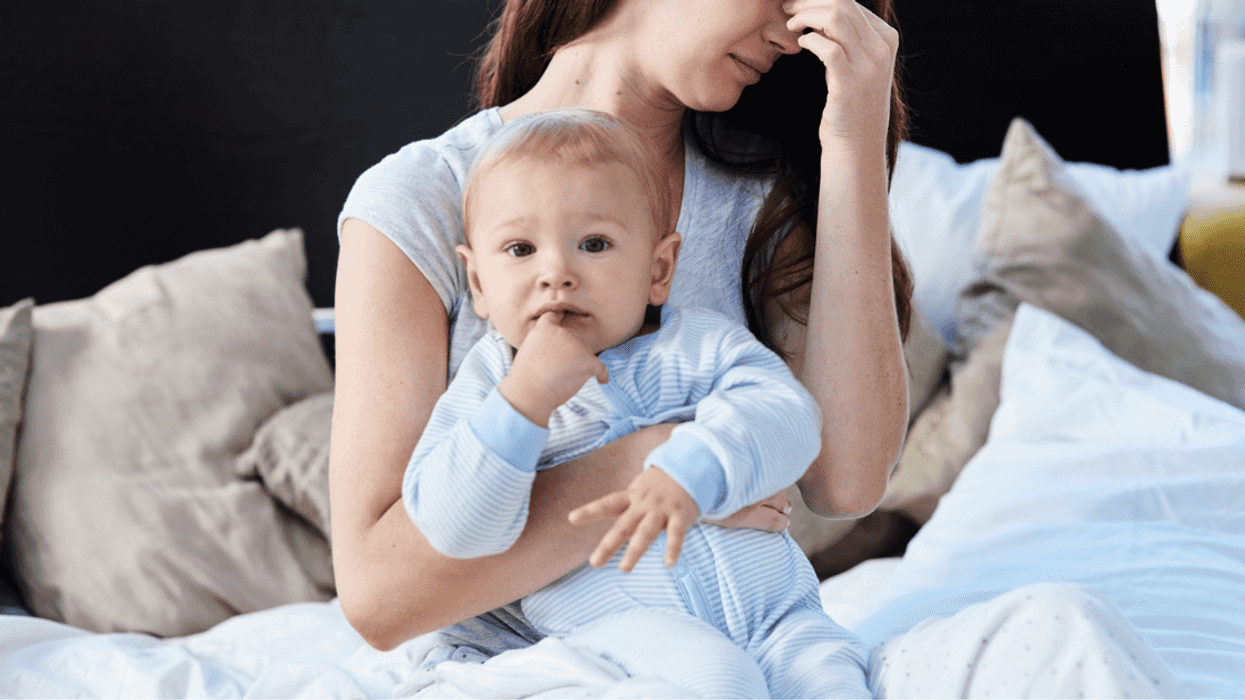 Unhappy woman holding someone else's baby