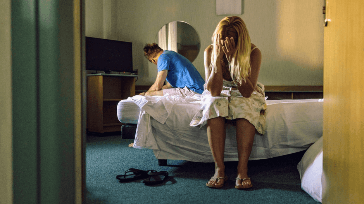 upset couple seated on bed