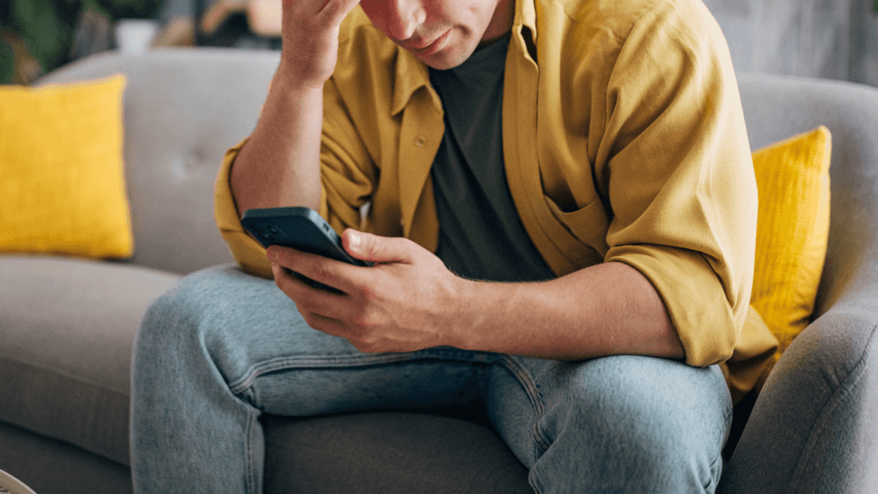 Upset man looking at his phone