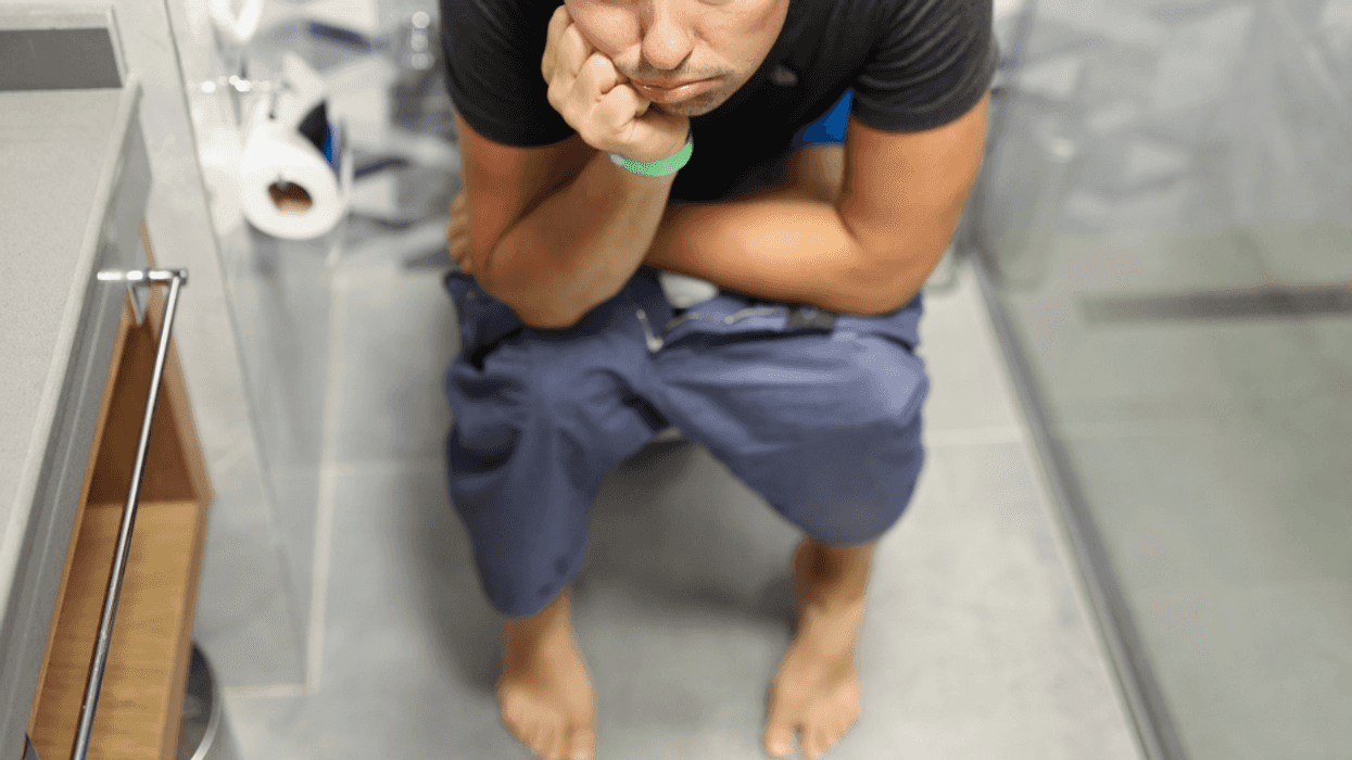 upset man seated on toilet