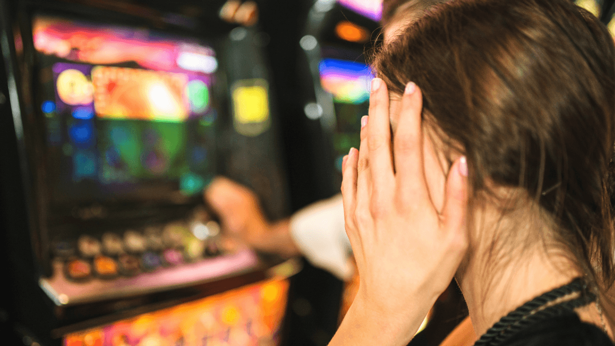 upset woman at slot machines