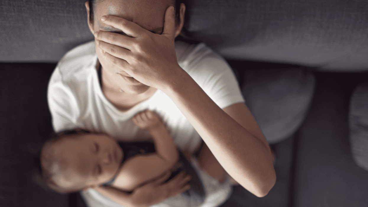 Upset woman holding her baby