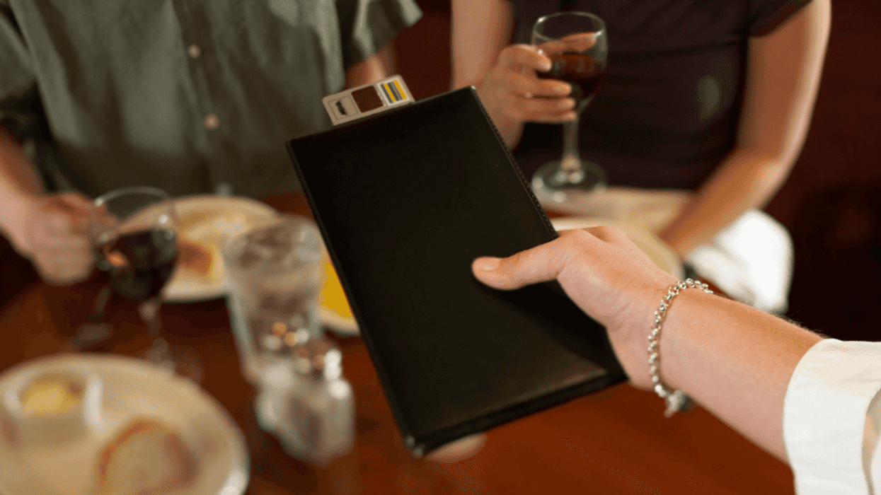 Waiter arriving with check
