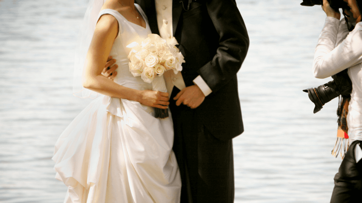 Wedding photographer taking photos of bride and groom