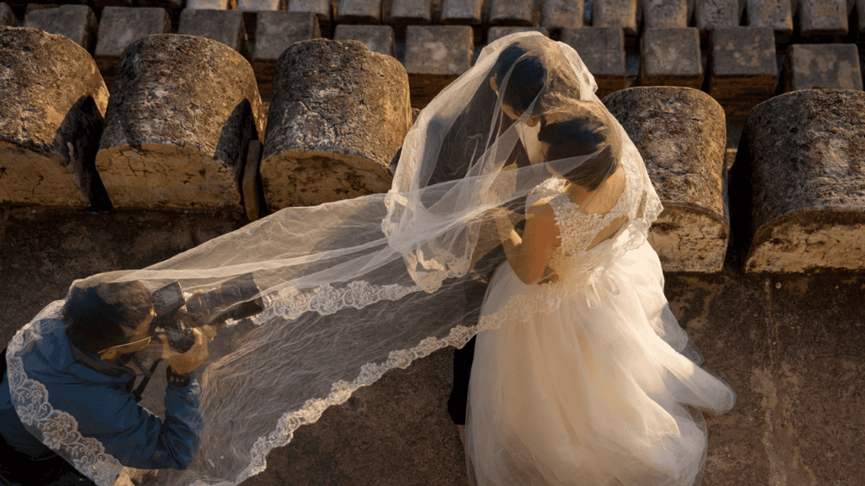 Wedding photographer with bride and groom