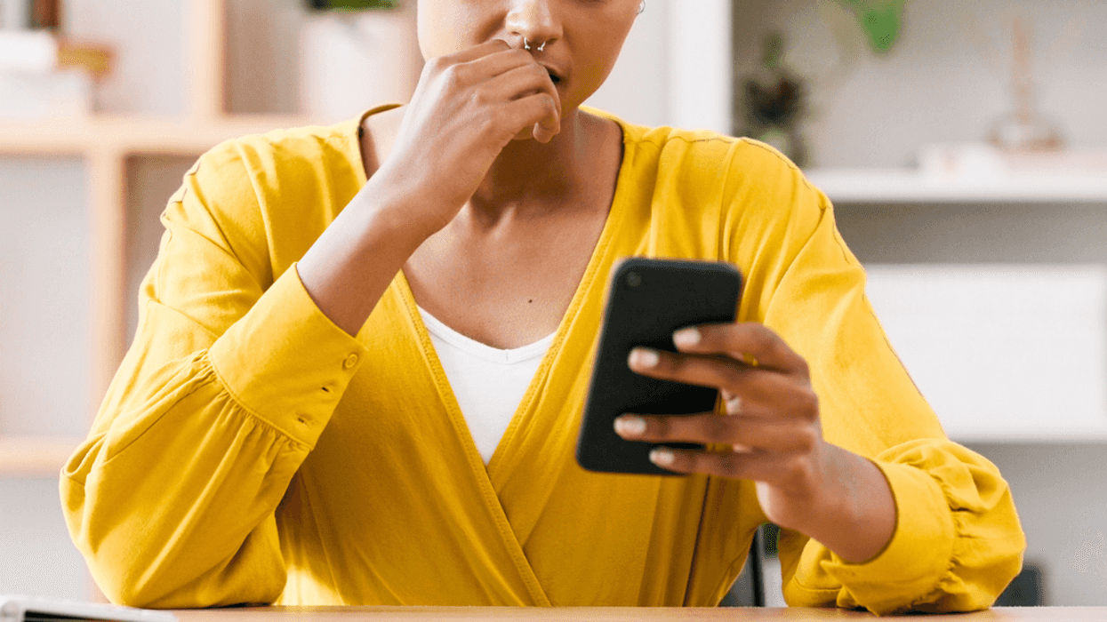 Woman angry while looking at her phone