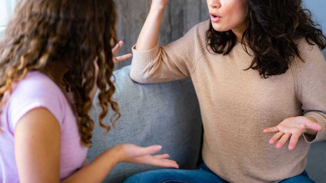 Woman argues with her teenage daughter while sitting at home.
