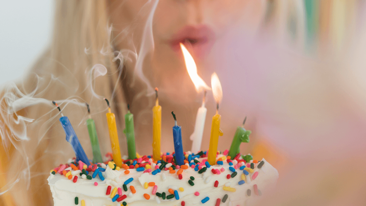 Woman blowing out birthday candles