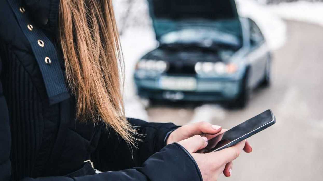 Woman calling for help because her car is broken.