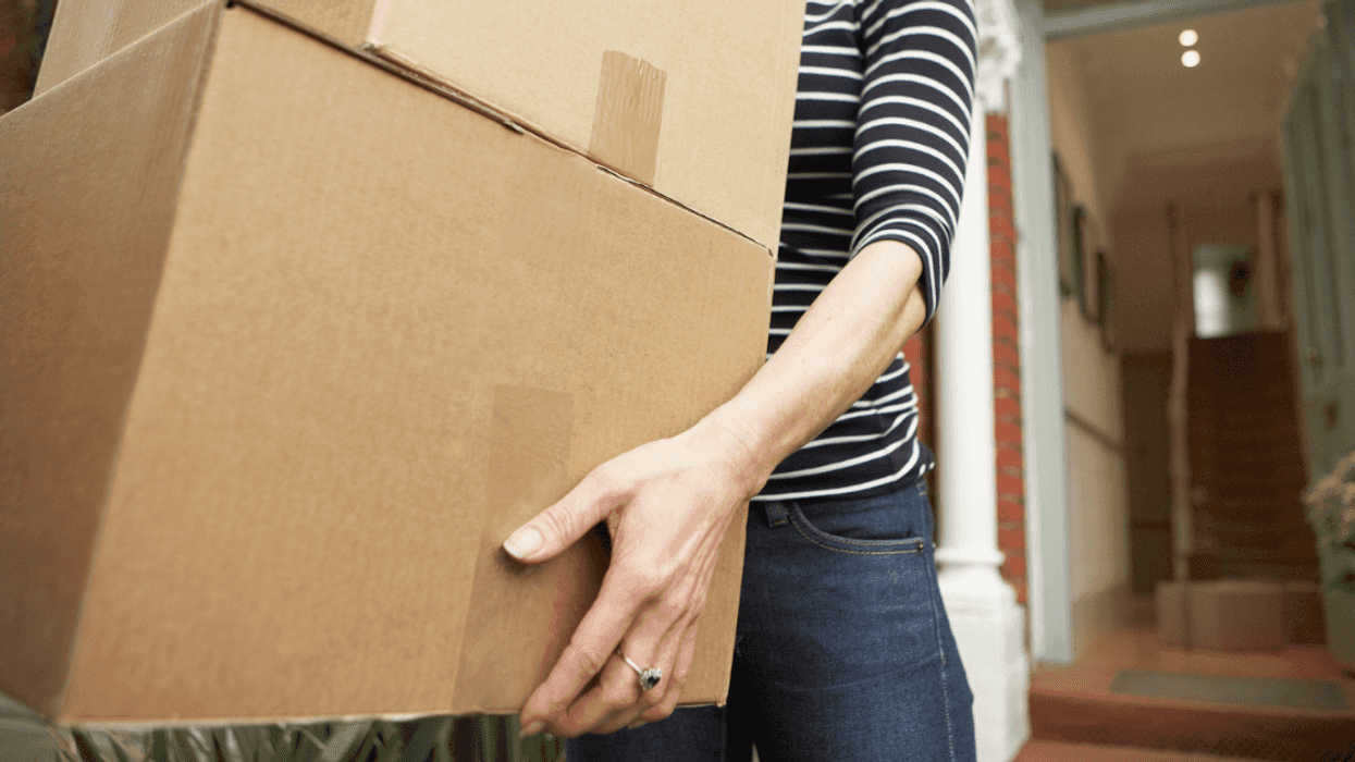 Woman carrying moving boxes