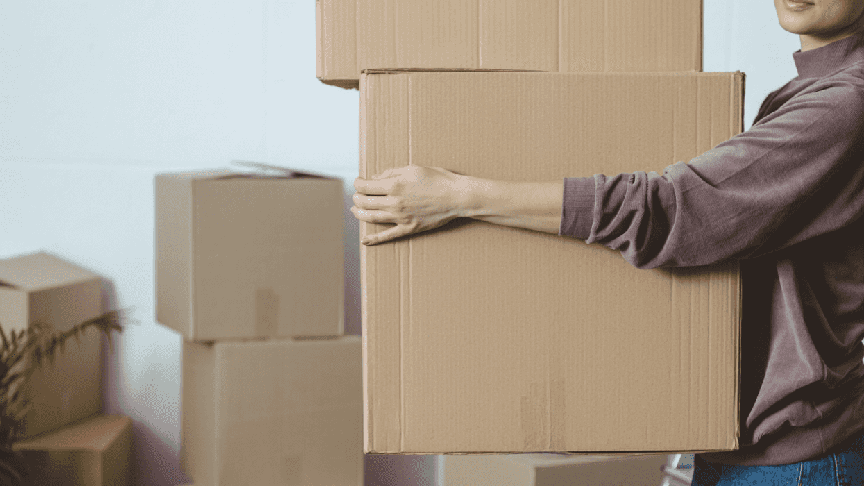 woman carrying moving boxes