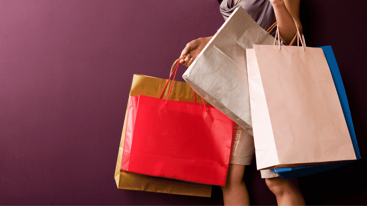 woman carrying multiple shopping bags