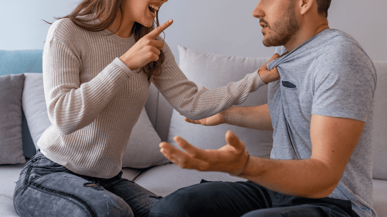 woman chastises man while on sofa