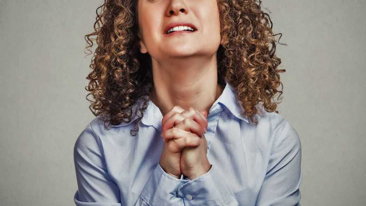 Woman clasping hands together and begging
