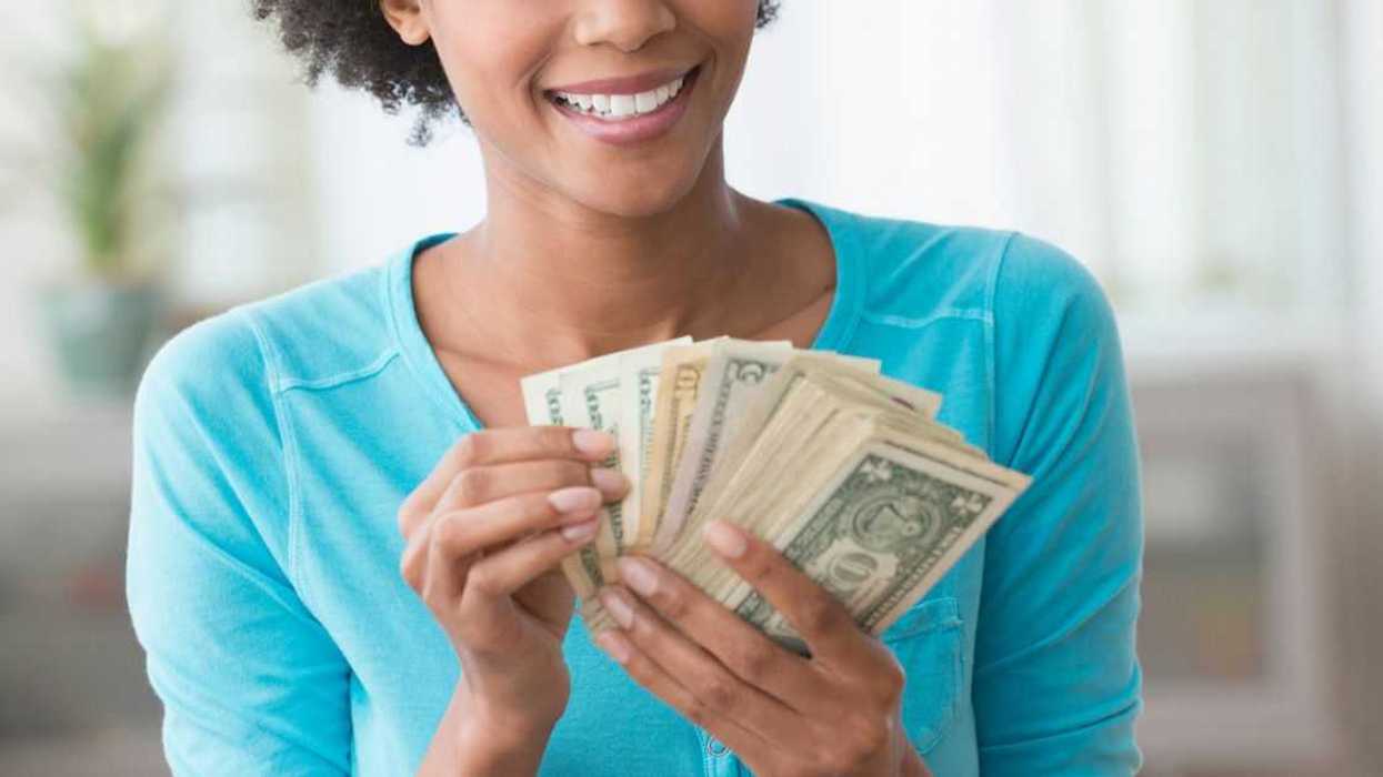 Woman counting money in living room