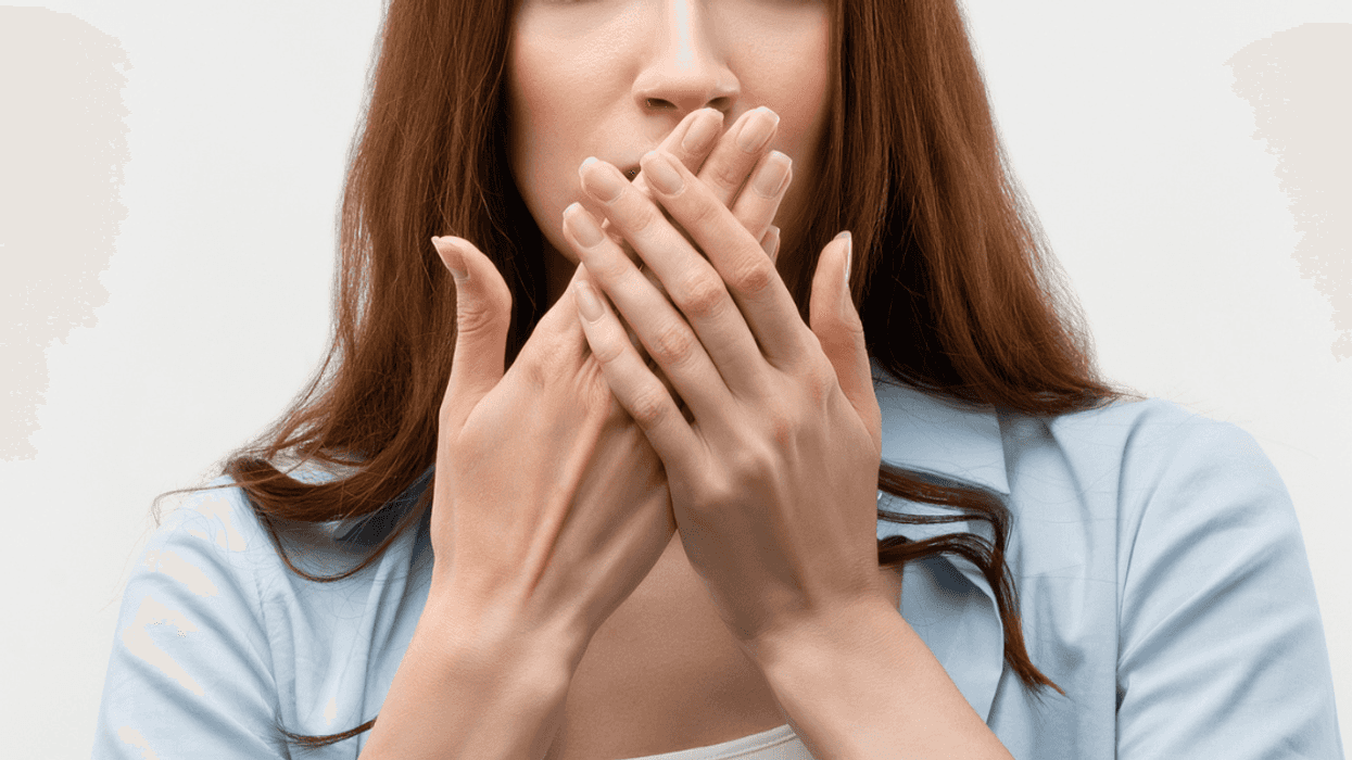 Woman covering her mouth