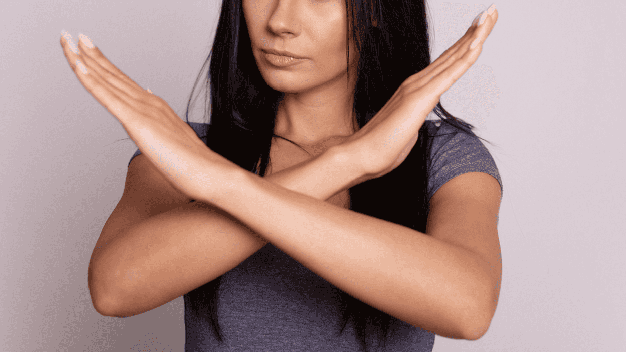 Woman crossing her arms in a 'no' motion