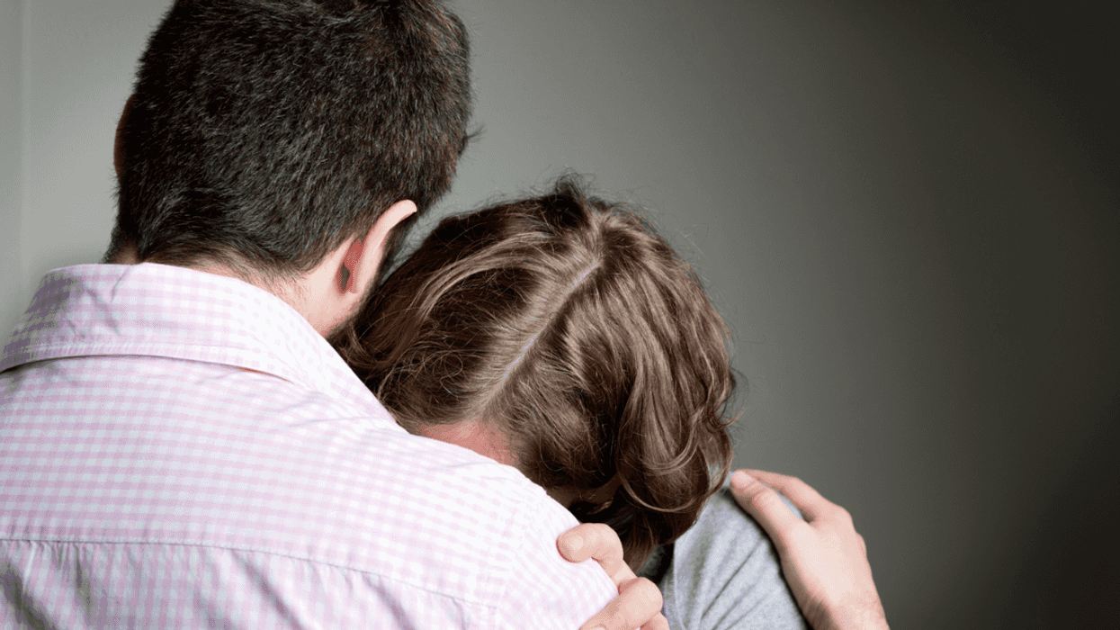 Woman crying on man's shoulder