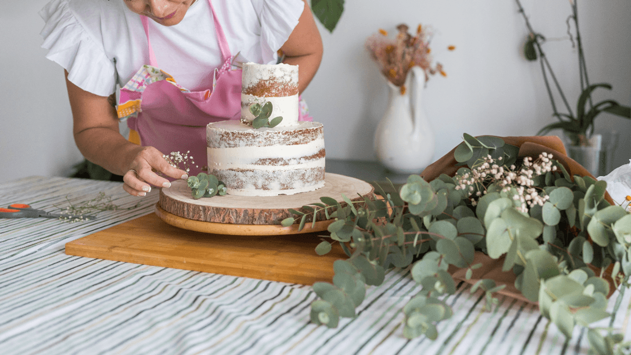 woman decorating a wedding cake