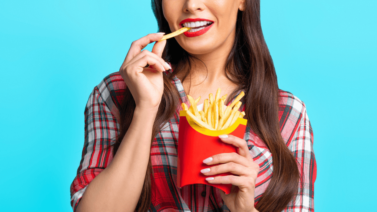 Woman eating french fries