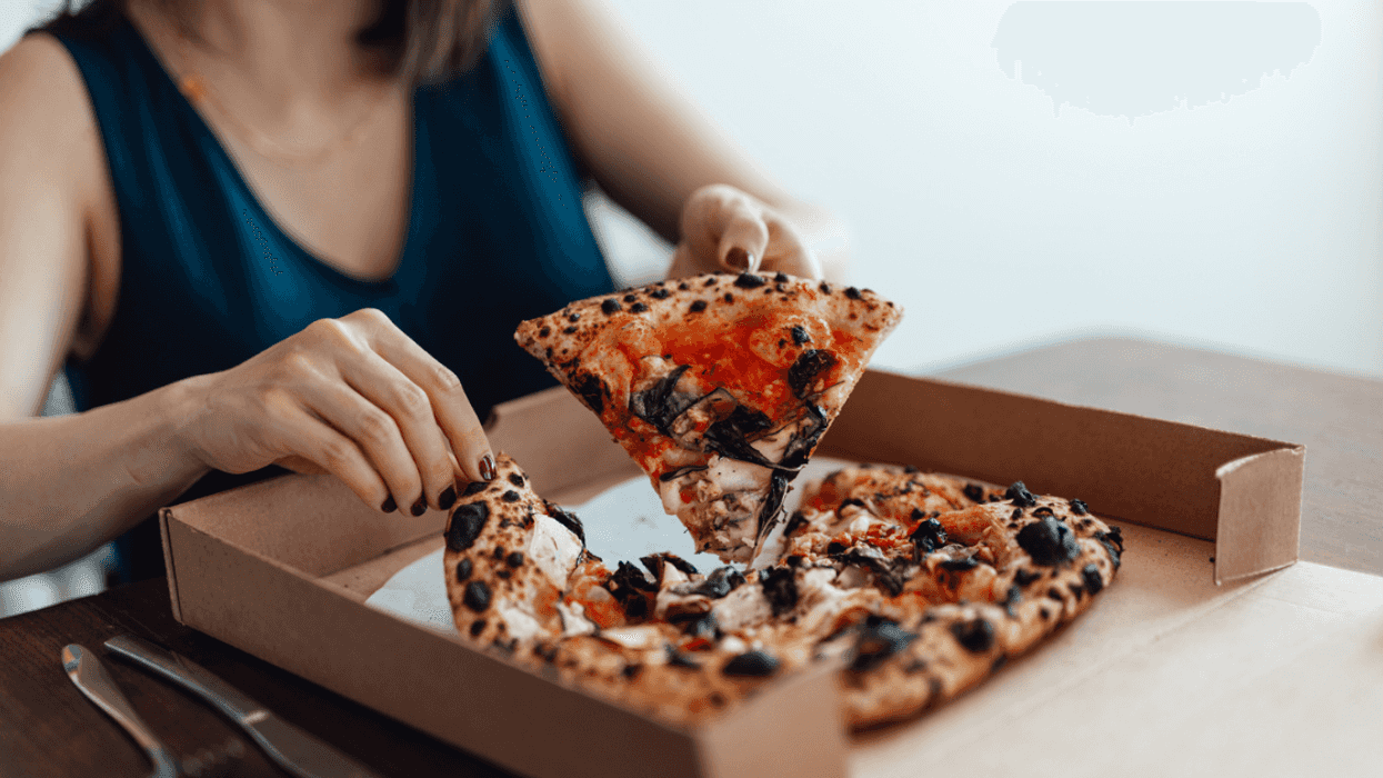 woman eating pizza