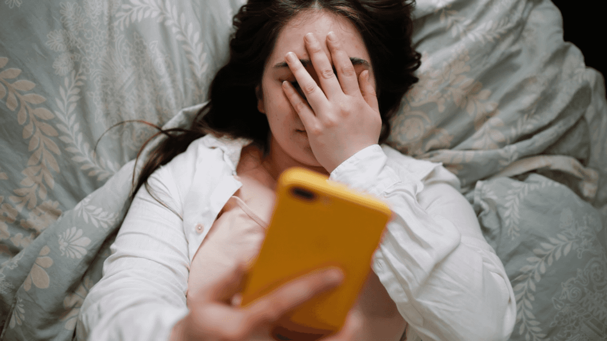 Woman embarrassed while looking at phone