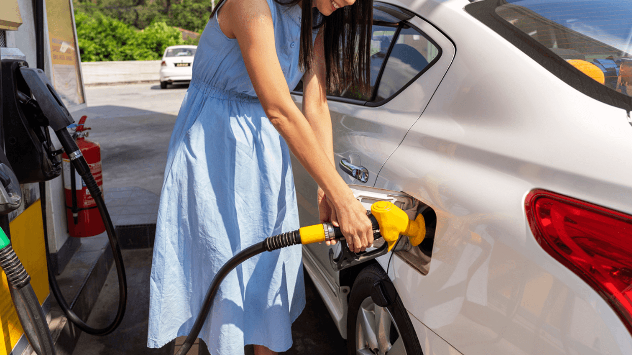 woman filling her car with gas