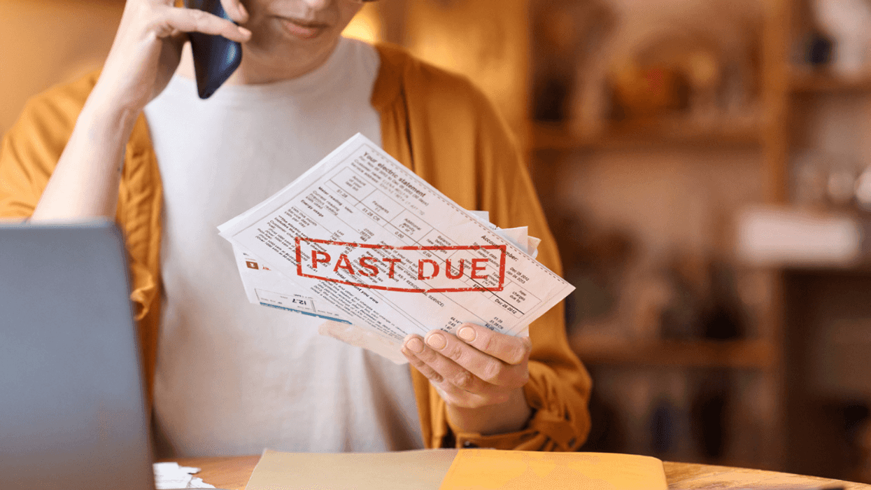 Woman frustrated while looking at past due bills