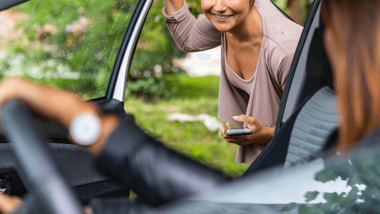 woman getting into car