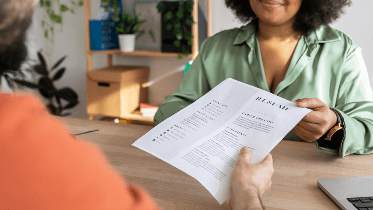 Woman handing a resume for a job interview.