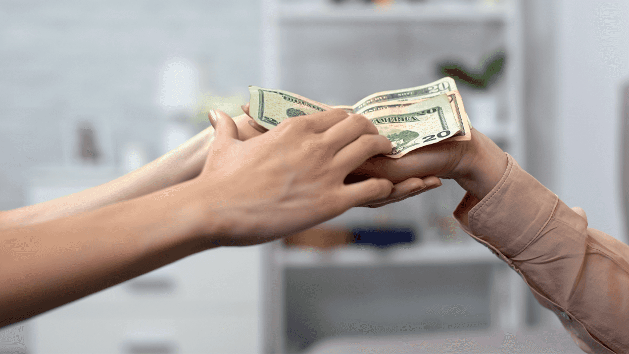 woman handing another woman money