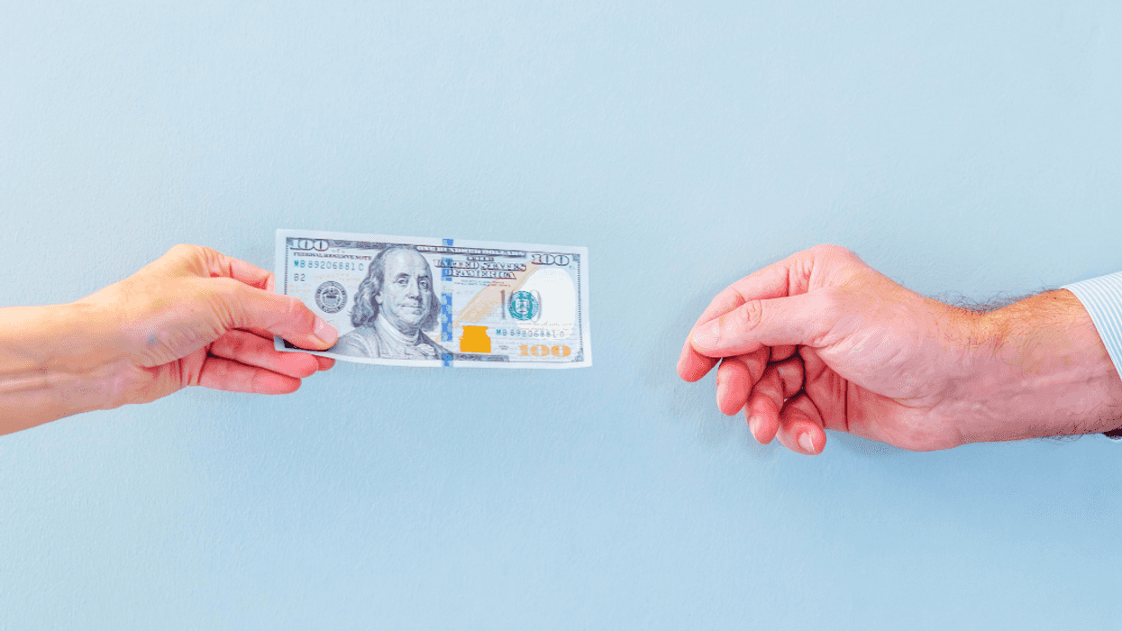 woman handing money to man