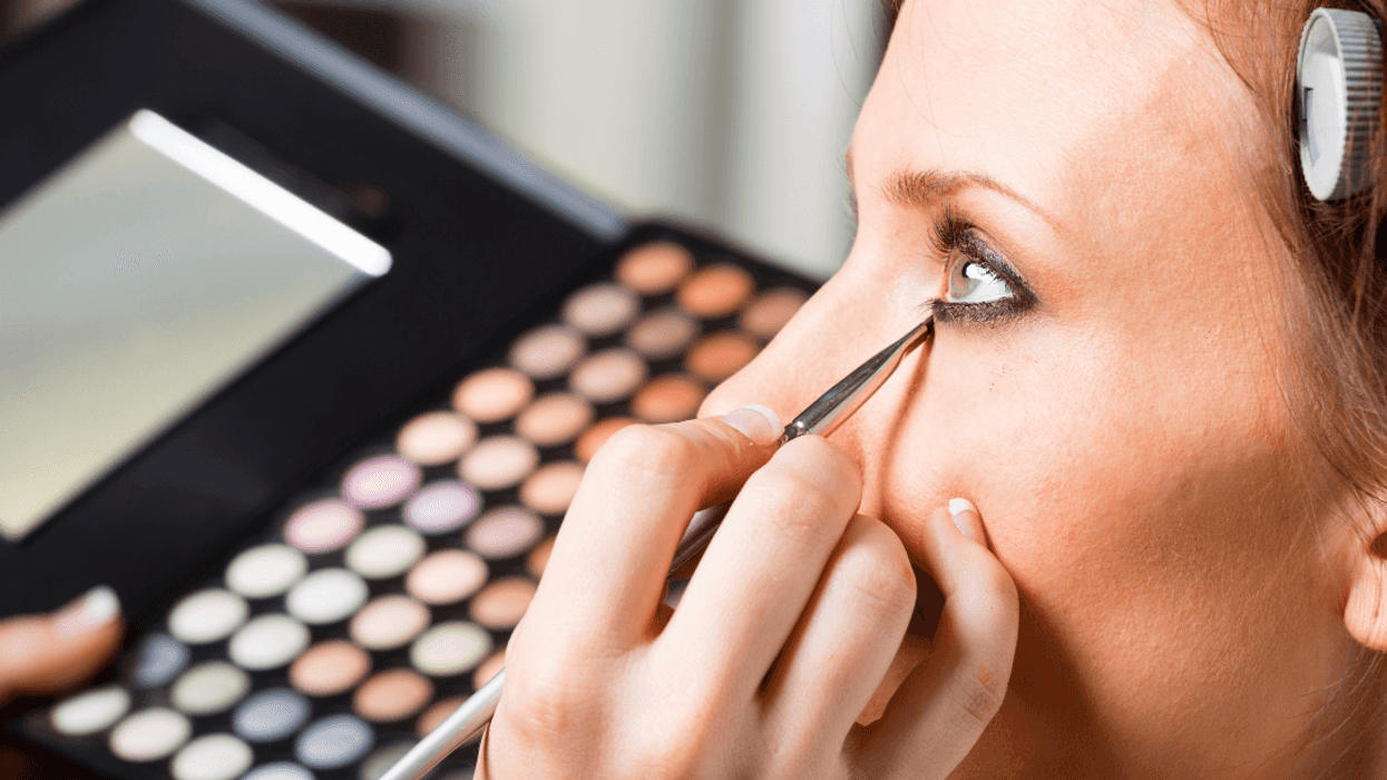 woman having makeup applied
