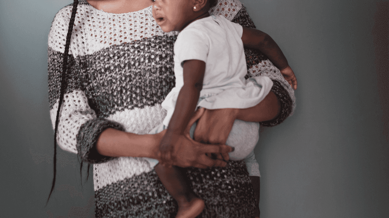 Woman holding a baby.