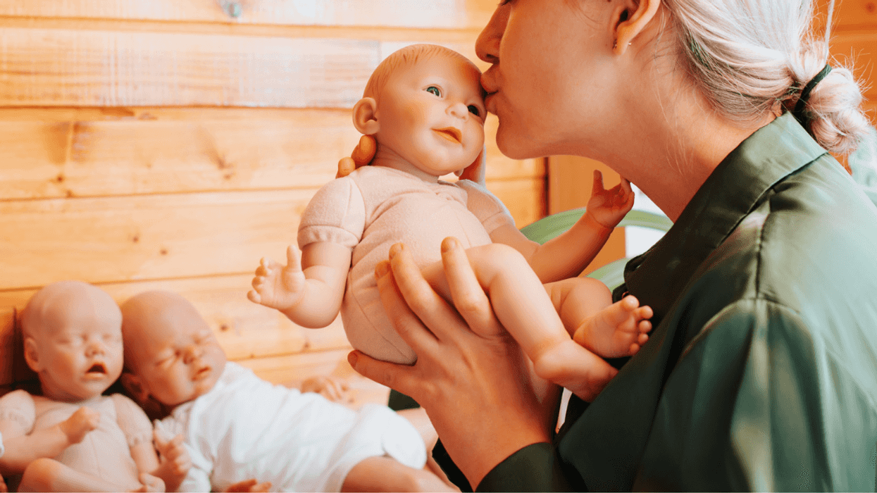 Woman holding a 'reborn' baby doll