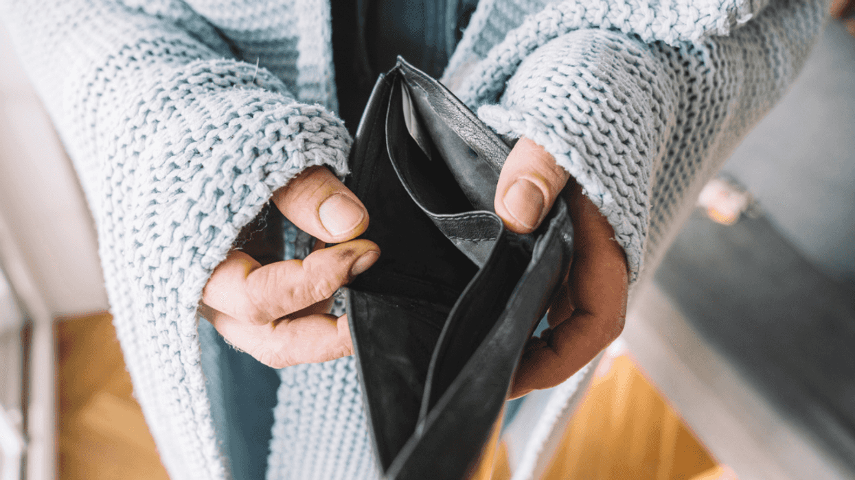 Woman holding an empty wallet.