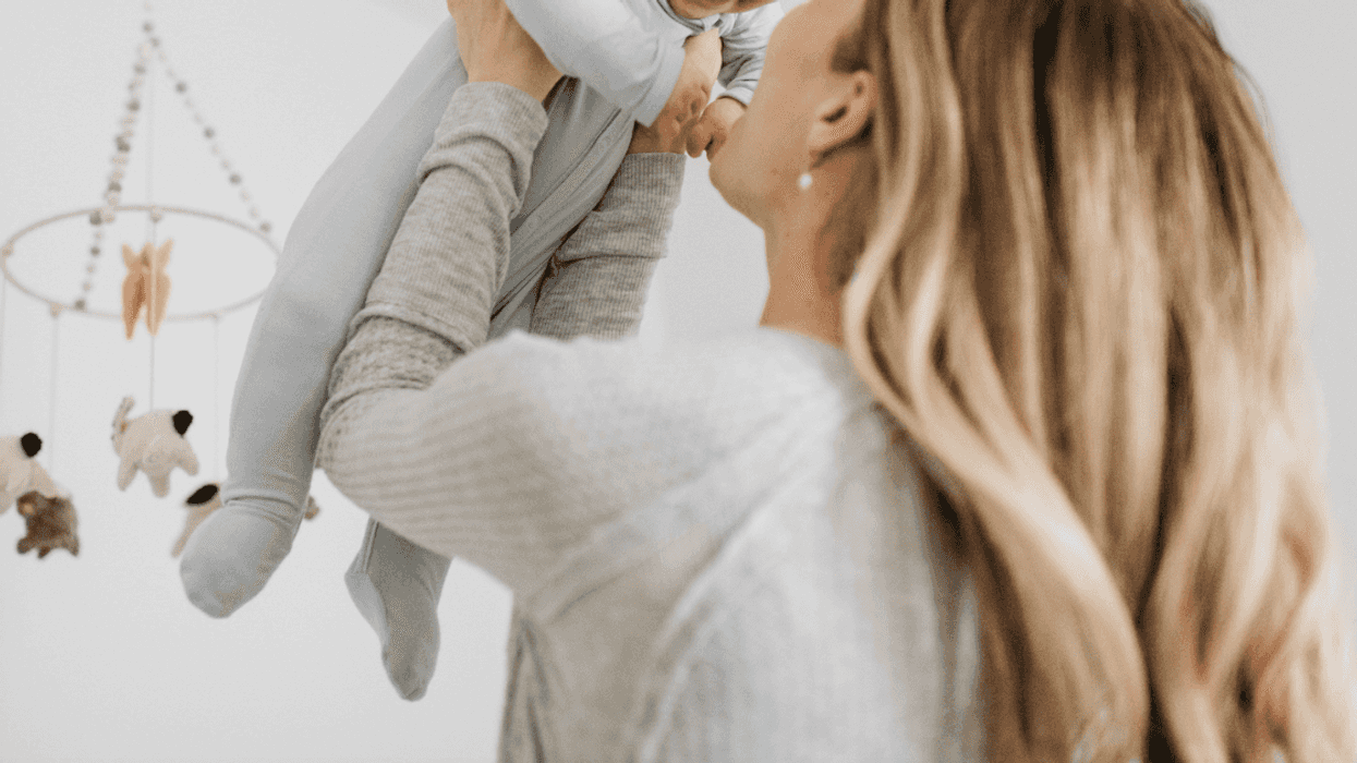 woman holding baby up
