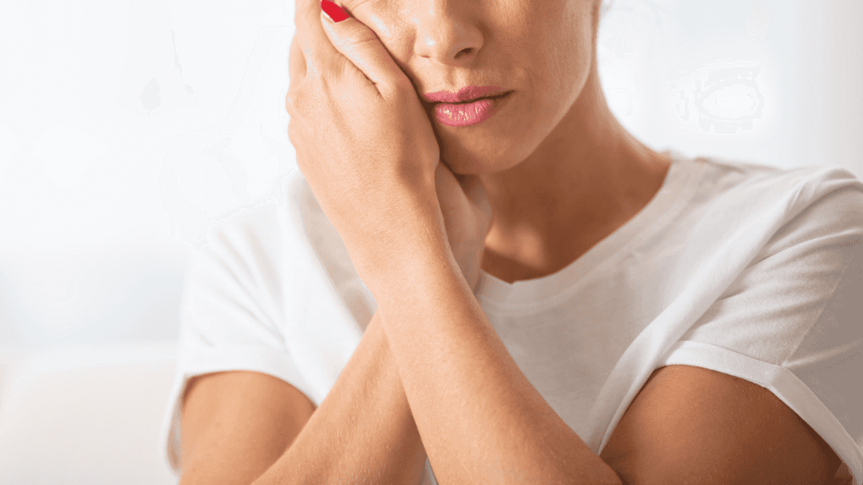 Woman holding cheek after being slapped