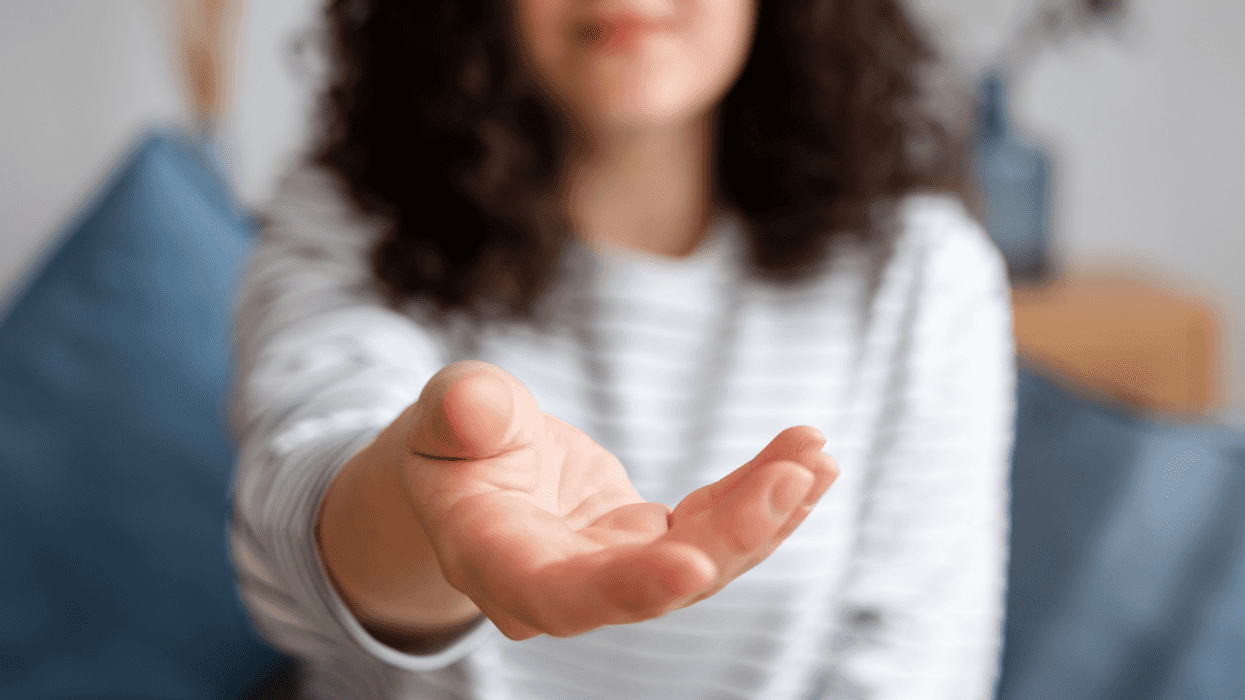 woman holding hand out asking for something
