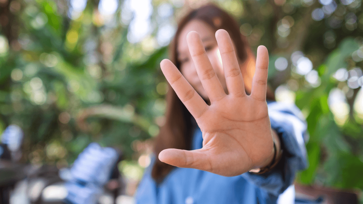Woman holding her hand up in "stop" motion
